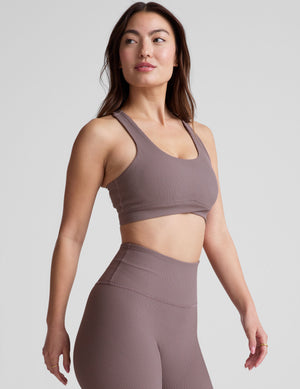 brown medium support racerback bra with a scoop neckline​, overlapping hemband detail​, is lined with performance lining and powermesh in between​, and has removable bra pads​. 