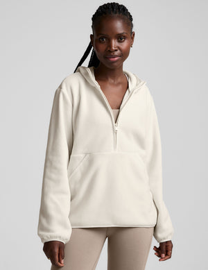 white fleece quarter zip jacket with a kangaroo pocket. 