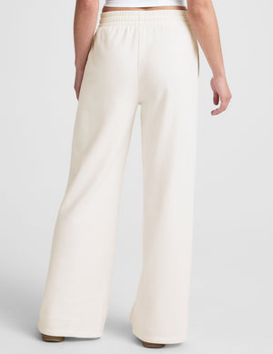 white mid-rise wide leg sweatpants with side slits and a drawcord at waistband. 
