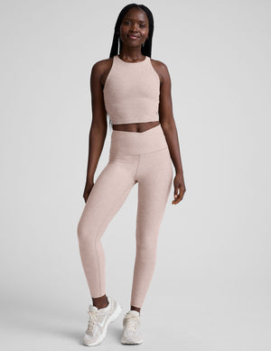 Woman wearing a chai athletic outfit on a white background