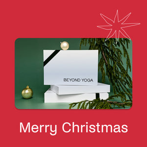 White box with 'BEYOND YOGA' branding on a green background with Christmas decorations, on a red border with 'Merry Christmas' text.